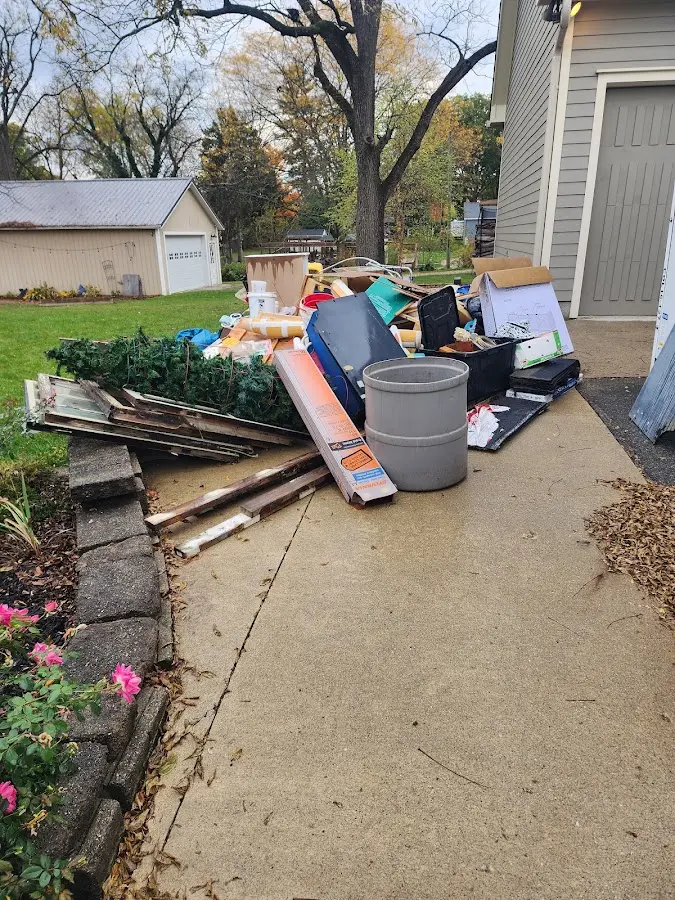 Dumpster being loaded with debris for Estate Cleanout Dumpster Rental in Yuba City